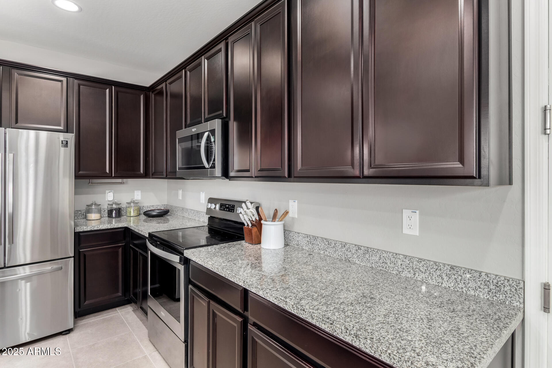 17160 North 9th Place Phoenix, AZ 85022 - Photo 14 of 46 a kitchen with stainless steel appliances granite countertop a sink stove and refrigerator