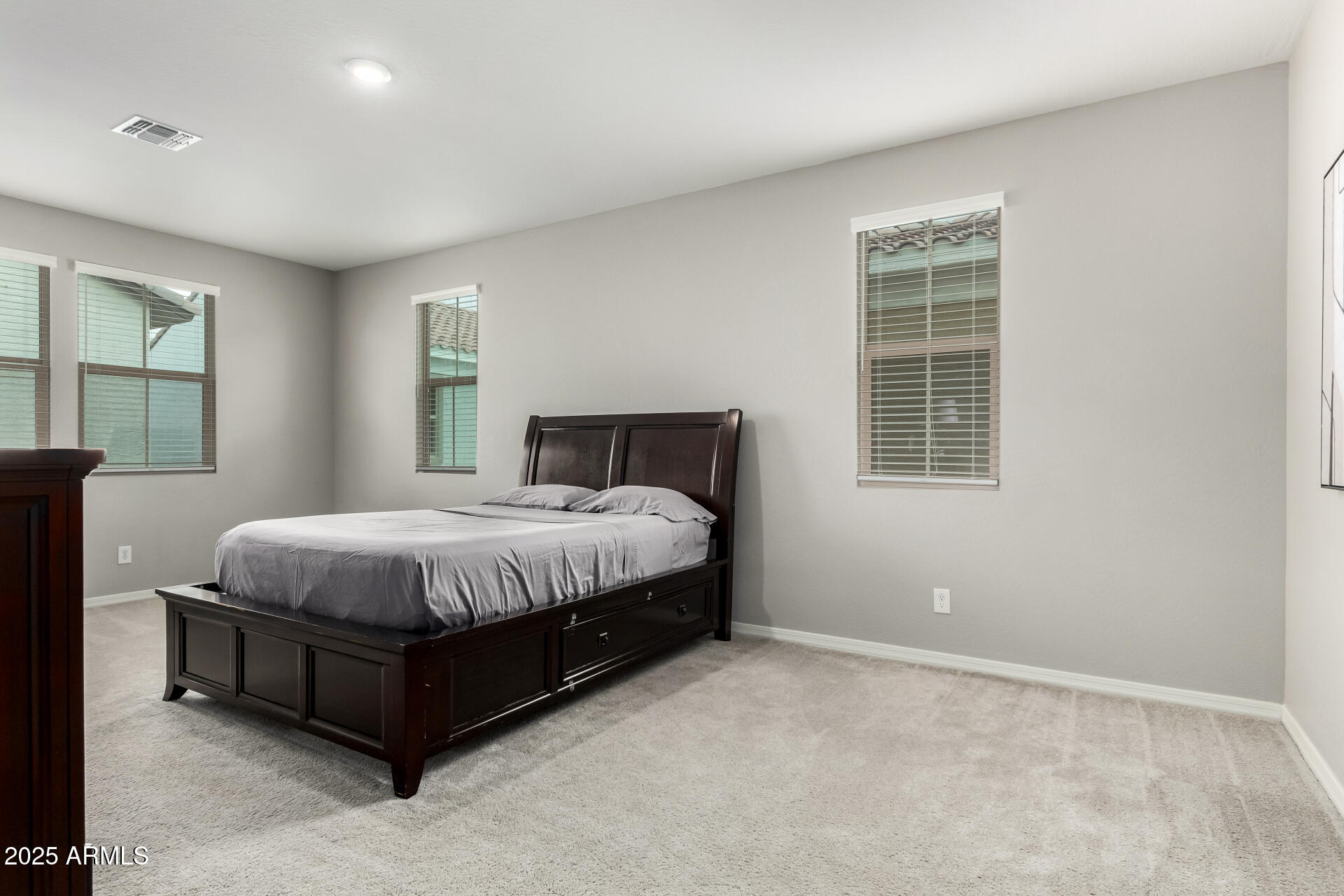 17160 North 9th Place Phoenix, AZ 85022 - Photo 16 of 46 a spacious bedroom with a bed and wooden floor