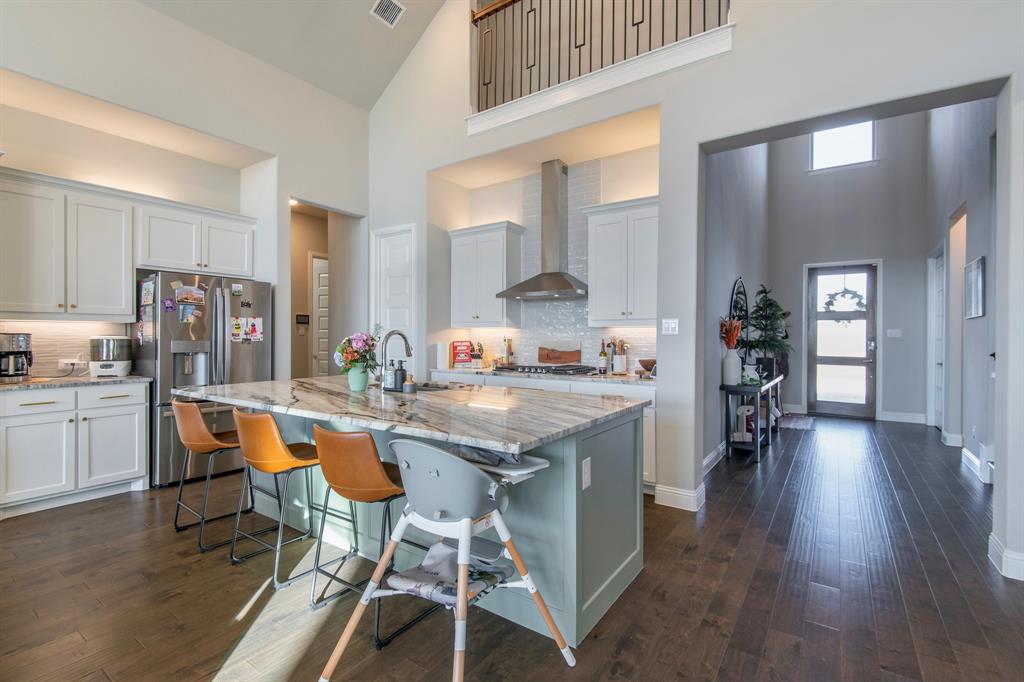 16650 Nightshade Road Frisco, TX 75033 - Photo 10 of 40 a open kitchen with stainless steel appliances granite countertop a table chairs refrigerator and sink