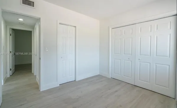 an empty room with closet area
