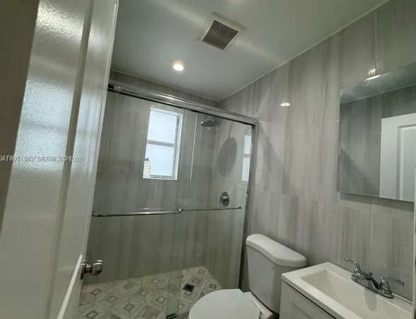 a bathroom with a toilet sink and shower