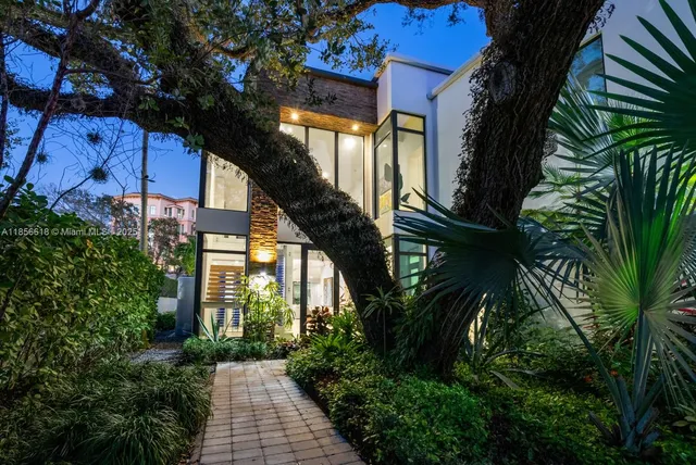 a large white kitchen with a large counter top appliances and cabinets