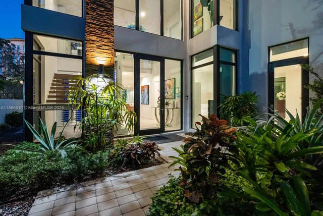 a kitchen with stainless steel appliances kitchen island granite countertop a sink and a refrigerator