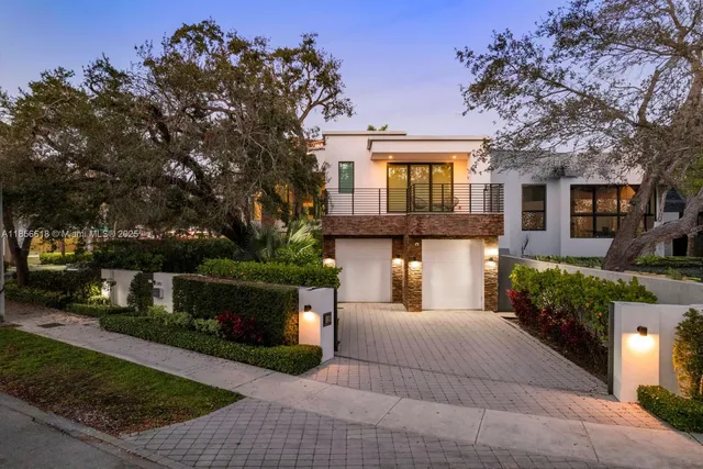 a kitchen with stainless steel appliances granite countertop a sink and white cabinets