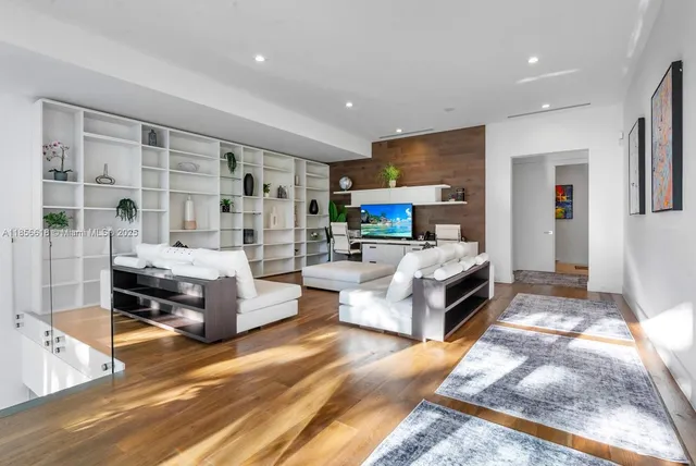 a bathroom with a double vanity sink a mirror and a potted plant