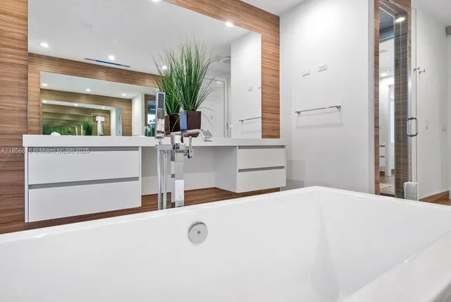 a front view of a house with a yard and potted plants
