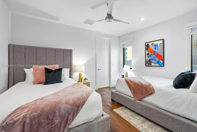 a view of a patio with table and chairs potted plants and palm tree