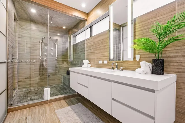 a view of a house with pool fire pit and chairs in patio