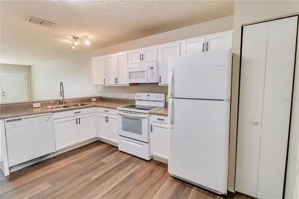 a white refrigerator freezer sitting in a kitchen