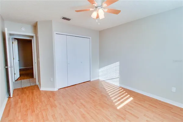 a view of empty room with wooden floor