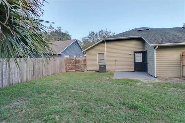 a view of a backyard with barn and large trees
