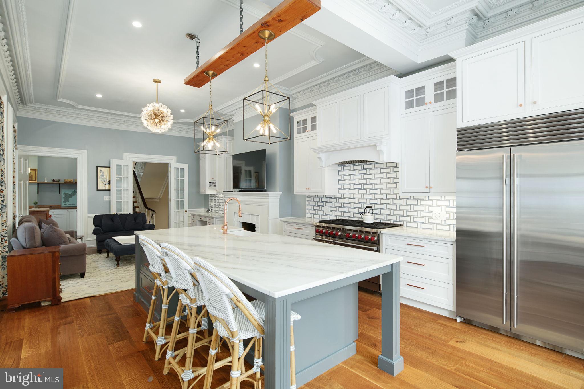 a kitchen with a stove a refrigerator and a fireplace