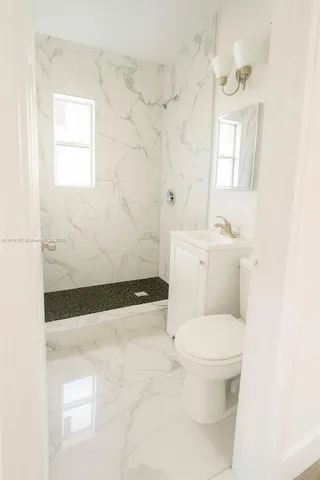 a bathroom with a toilet a sink and a shower