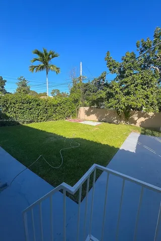 a view of a yard with table and chairs