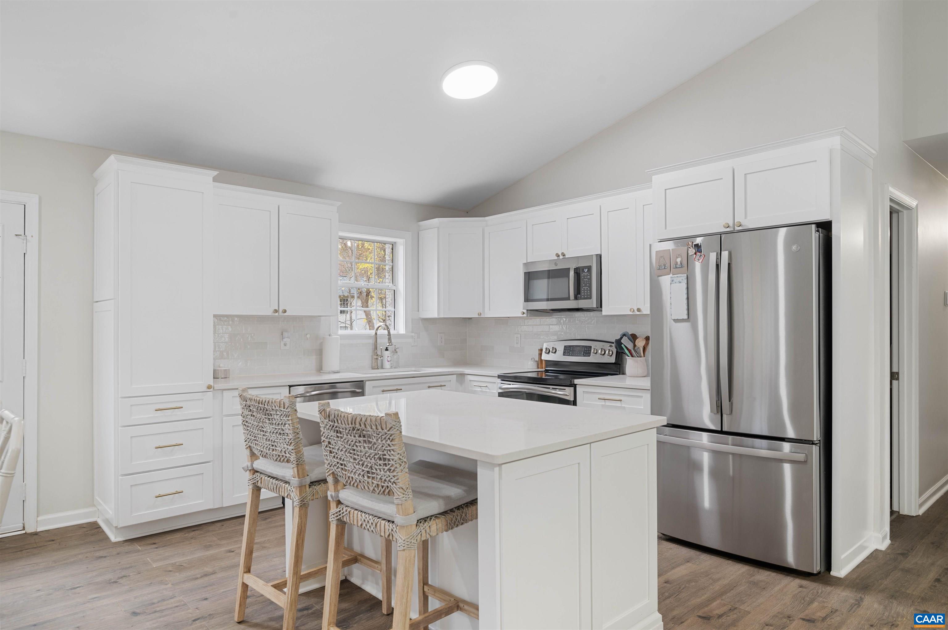 318 Larkspur Road Ruckersville, VA 22968 - Photo 13 of 42 a kitchen with stainless steel appliances a refrigerator stove microwave and cabinets