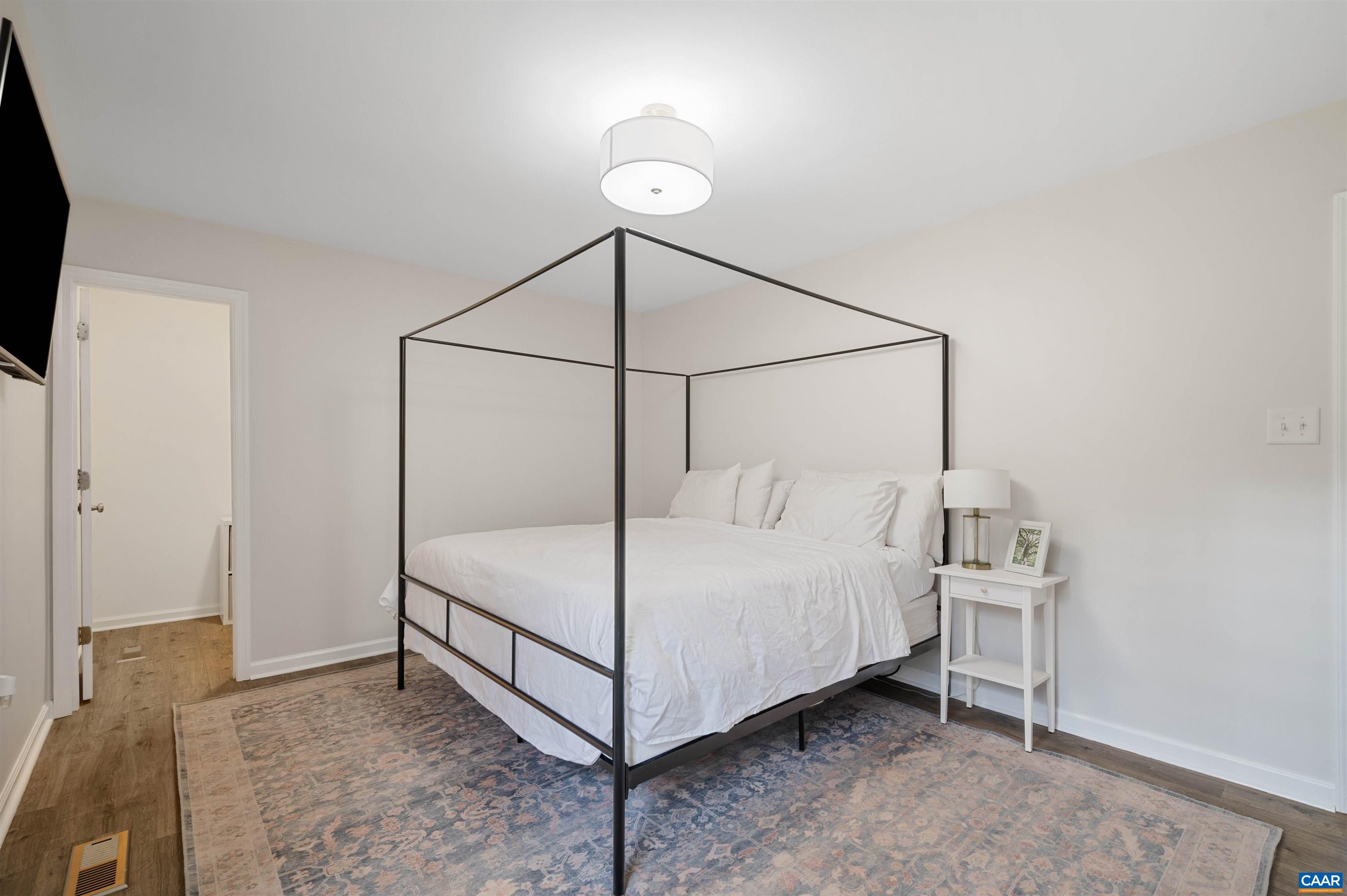 318 Larkspur Road Ruckersville, VA 22968 - Photo 23 of 42 a bedroom with a bed and a night stand