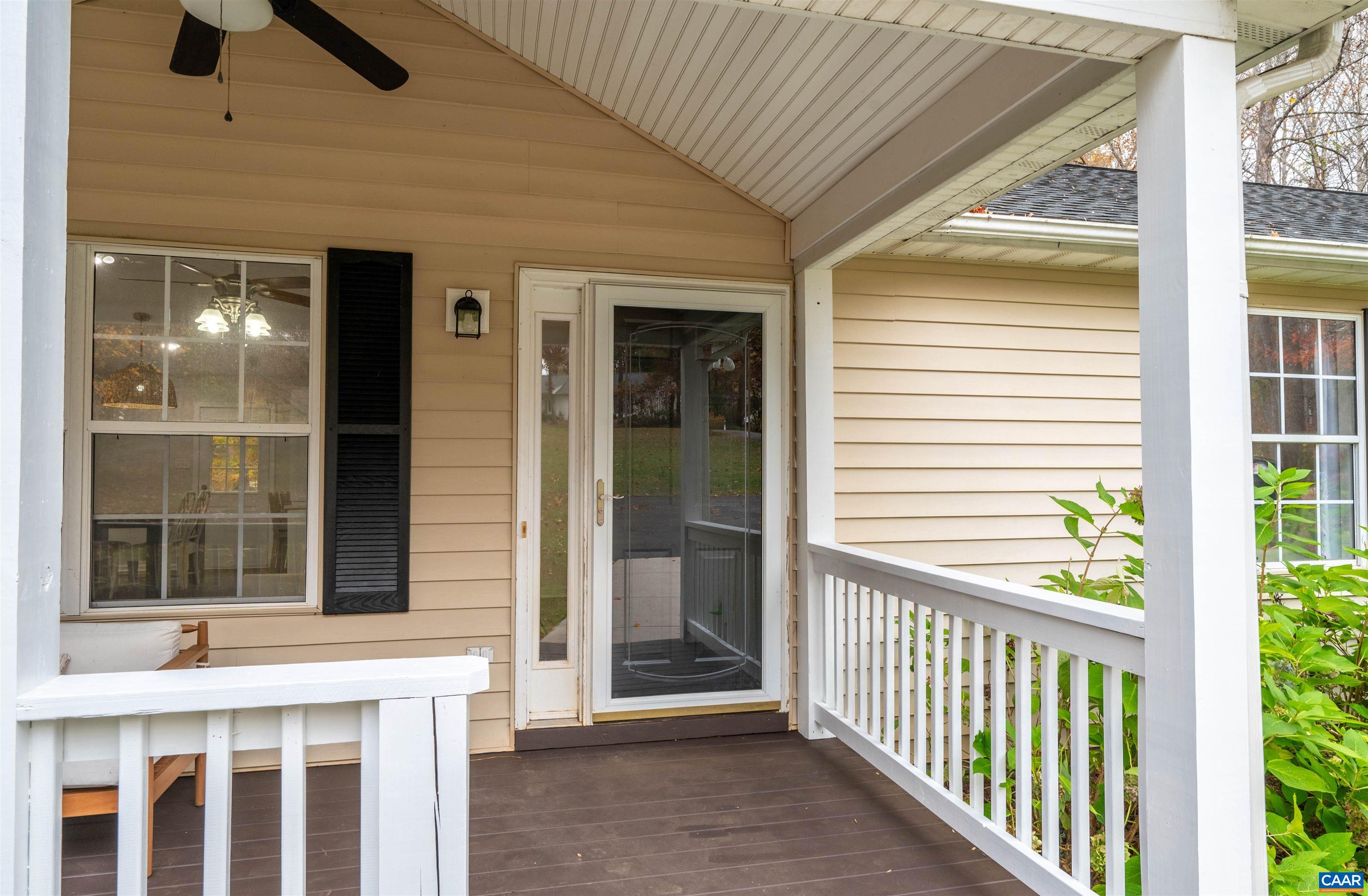 318 Larkspur Road Ruckersville, VA 22968 - Photo 5 of 42 a view of a porch with a table and chairs