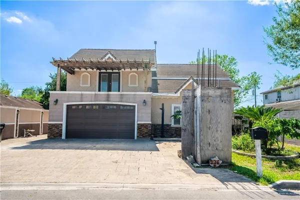 a front view of a house with a garden