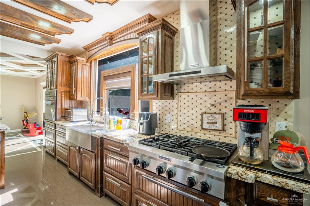 306 R Street Weslaco, TX 78596 - Photo 11 of 33 a kitchen with stove and cabinets