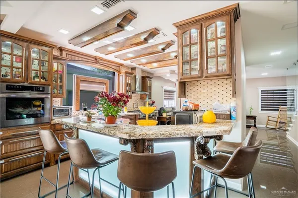 a view of a dining room with furniture a chandelier and wooden floor