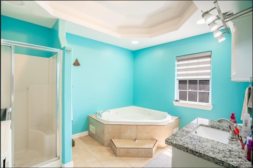306 R Street Weslaco, TX 78596 - Photo 18 of 33 a bathroom with a granite countertop sink toilet and shower