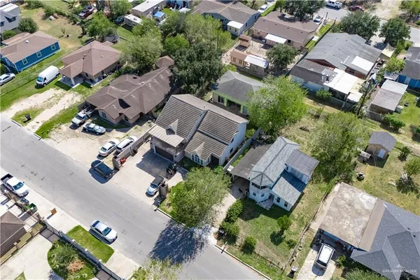 an aerial view of multiple houses with yard