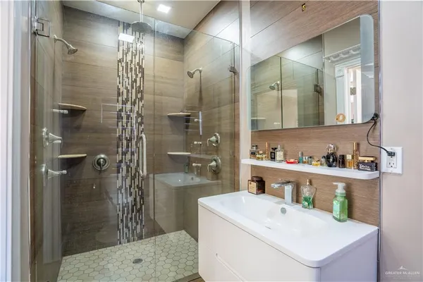 a bathroom with a sink a toilet and shower