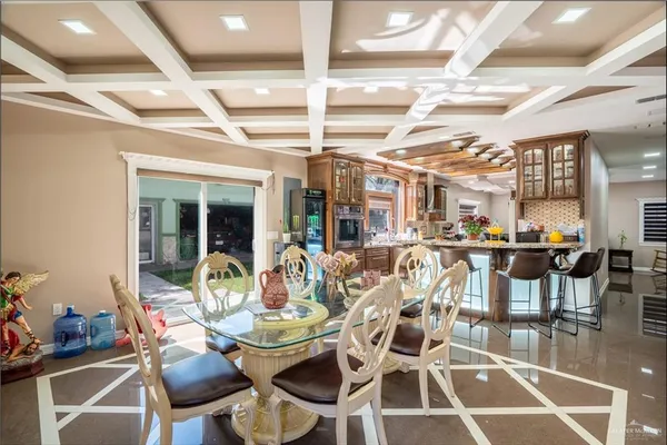a view of a dining room with furniture and chandelier
