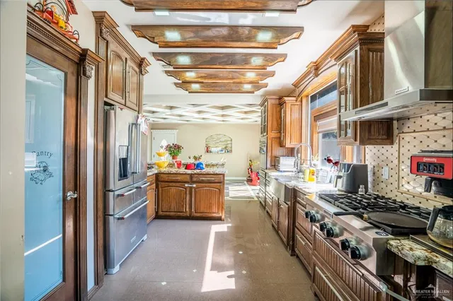 a kitchen with stove and refrigerator