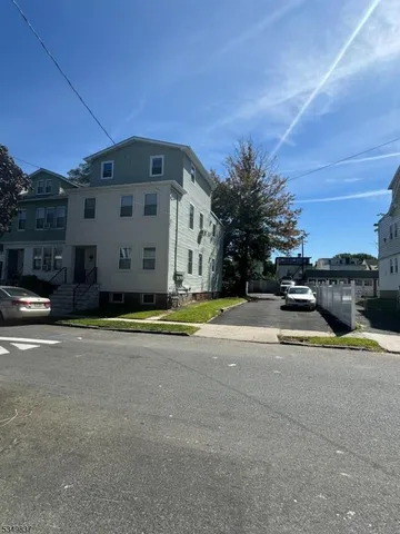 a view of a building with cars parked on road