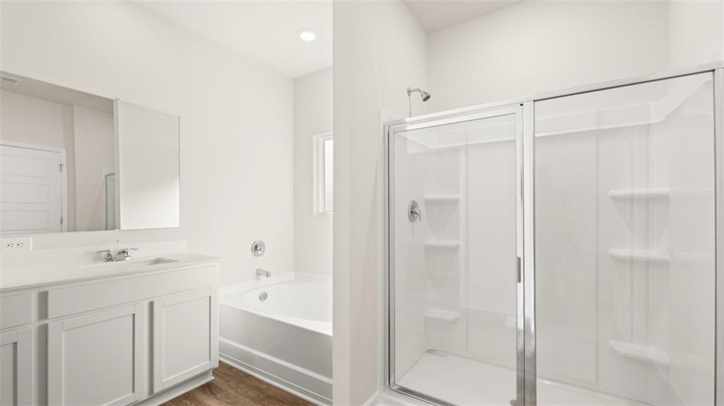 211 Cattle Drive Perry, GA 31069 - Photo 26 of 39 a bathroom with a bathtub shower sink vanity and a mirror