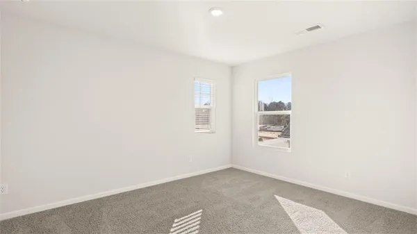 a view of a livingroom with an empty space and a window