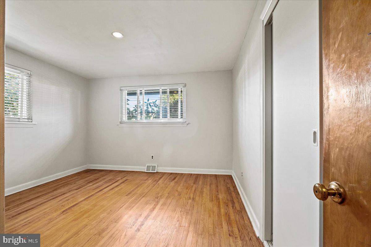 268 Buckner Avenue Haddonfield, NJ 08033 - Photo 25 of 51 an empty room with wooden floor and windows