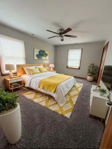 a bedroom with a bed a couch and a window