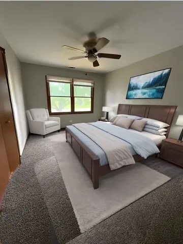 a bedroom with a bed couch and window