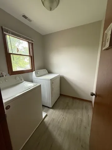 a room with a window a washer and dryer