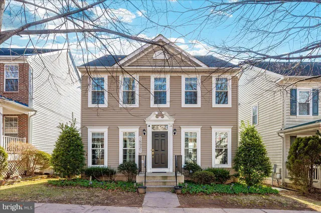 a front view of a residential houses with yard