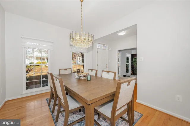 a view of a dining room with furniture and chandelier