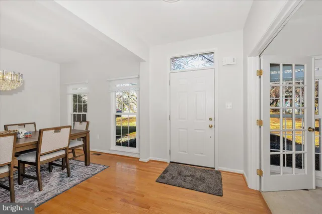 a view of an empty room with glass door and furniture