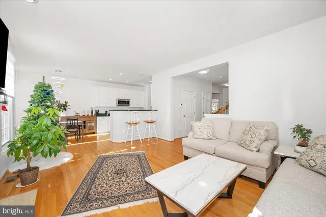 a living room with furniture wooden floor and a flat screen tv