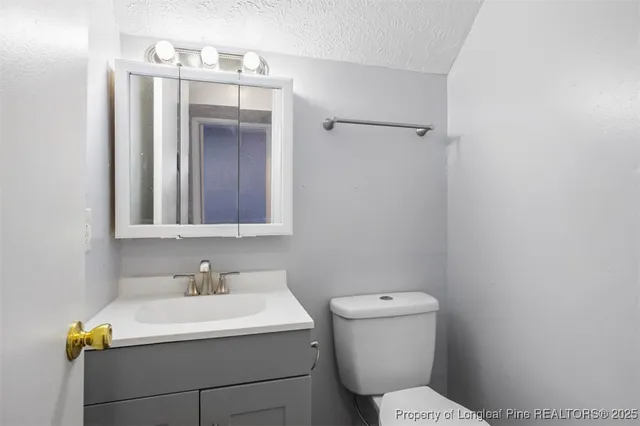 a bathroom with a sink a toilet and mirror