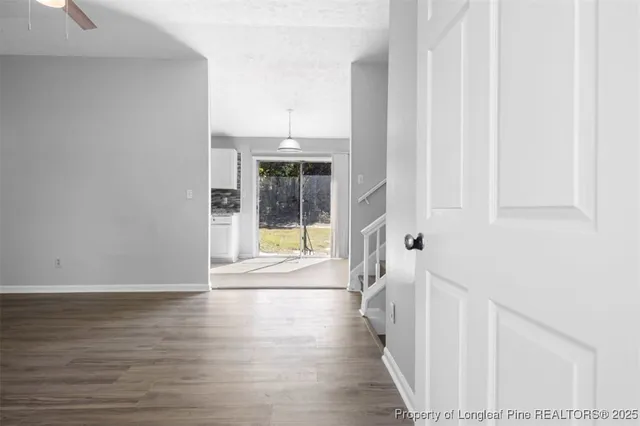 a view of an entryway with wooden floor