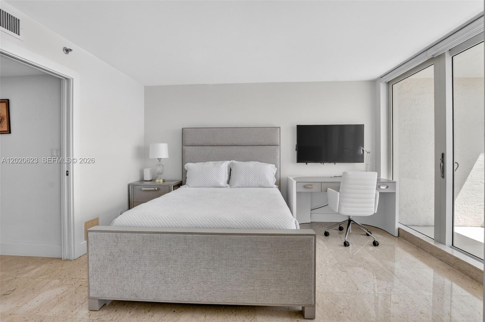 4101 North Ocean Boulevard, Unit 1605 Boca Raton, FL 33431 - Photo 15 of 35 a bedroom with a bed and a flat screen tv