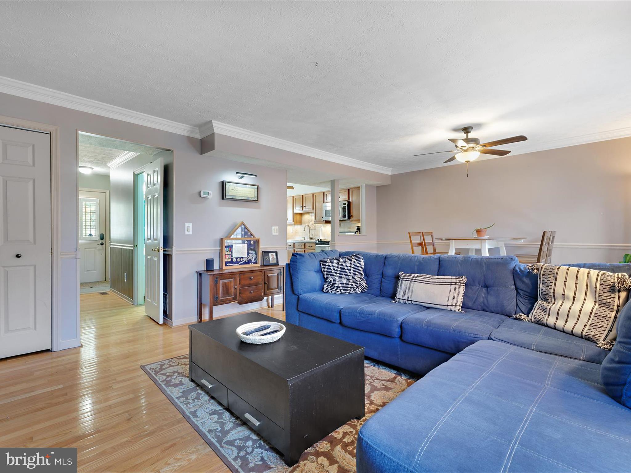 7824 Camp Road Pasadena, MD 21122 - Photo 13 of 33 a living room with furniture and a chandelier