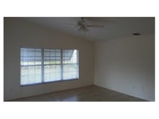 694 Southwest Heather Street Port St. Lucie, FL 34983 - Photo 3 of 13 a black and white photo of a living room