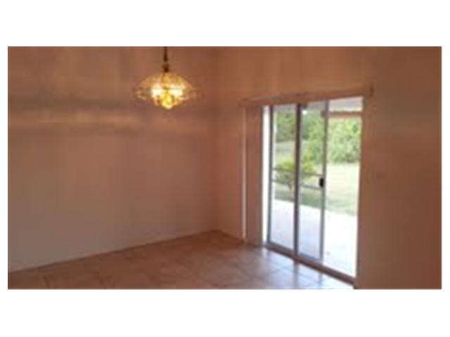 694 Southwest Heather Street Port St. Lucie, FL 34983 - Photo 4 of 13 a open living room with furniture