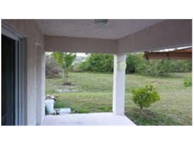 694 Southwest Heather Street Port St. Lucie, FL 34983 - Photo 5 of 13 a black and white photo of a garden