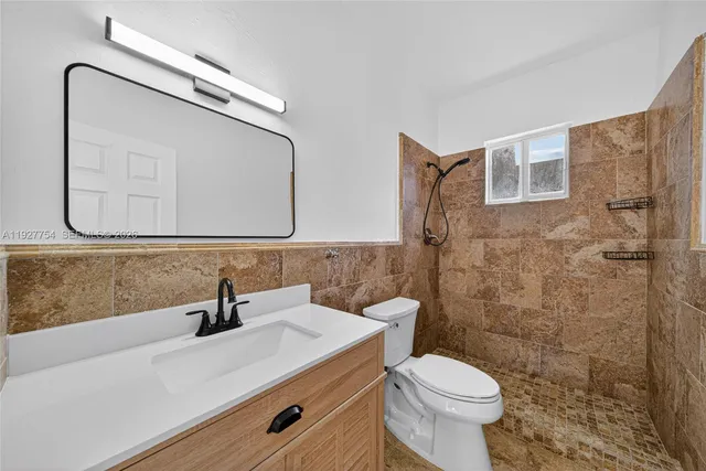 a bathroom with a sink a toilet and mirror