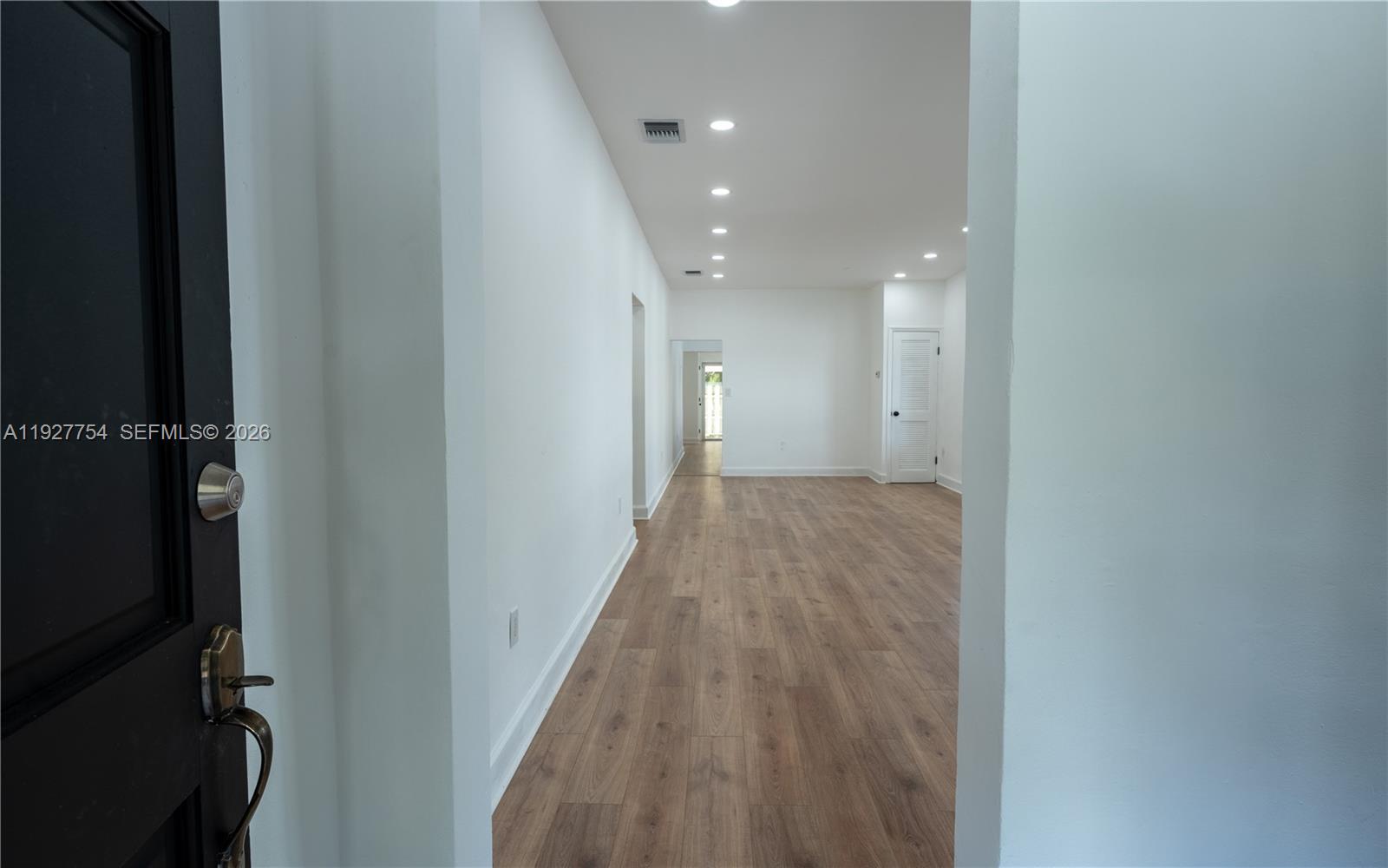 426 Southwest 26th Road Miami, FL 33129 - Photo 3 of 12 a view of a hallway with wooden floor