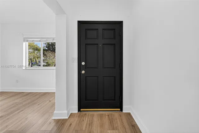 an empty room with wooden floor and closet